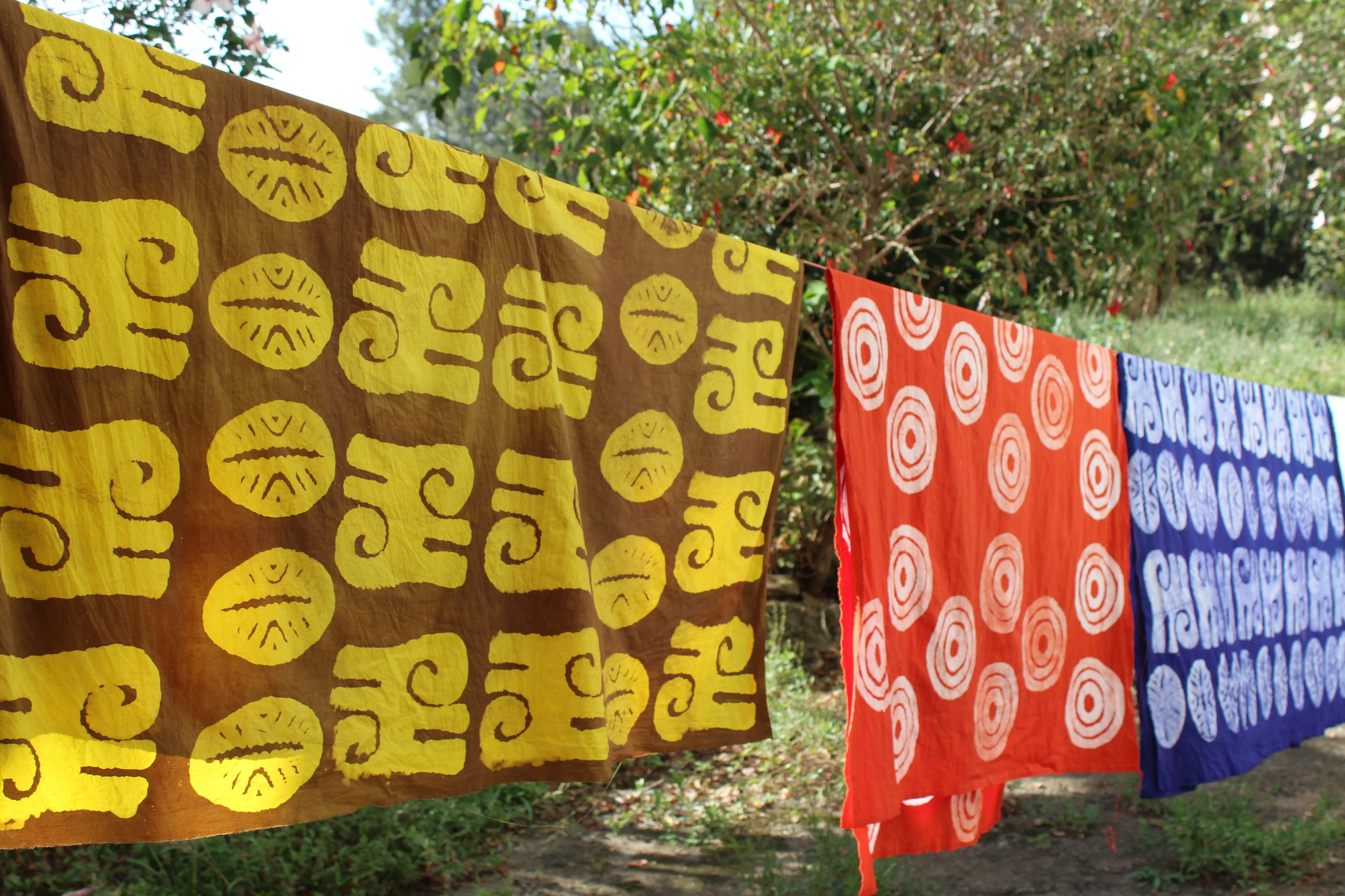 A batik maker working on a finished patterned cloth